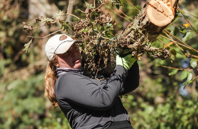 Student carrying a log