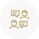 Golden icon of two heads with speech bubbles