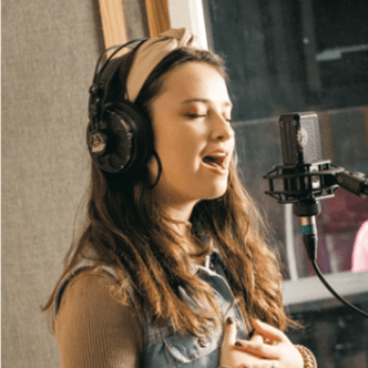 female student singing into a microphone