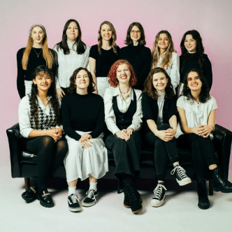Group of female students sitting on a black couch