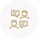 Golden icon of two heads with speech bubbles