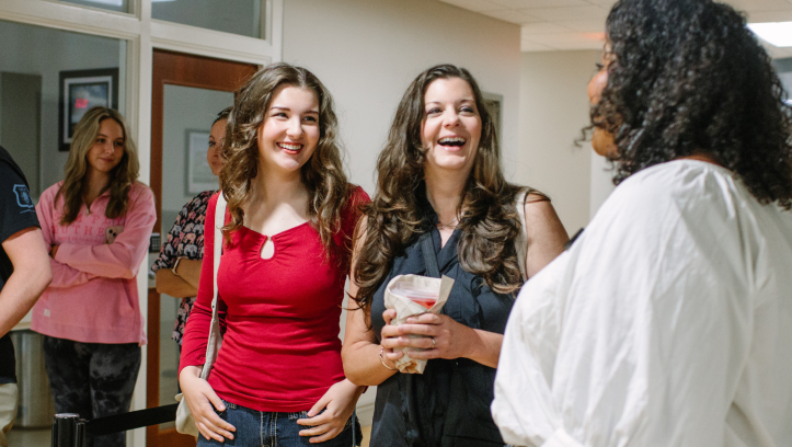 Prospective students talking with counselor.