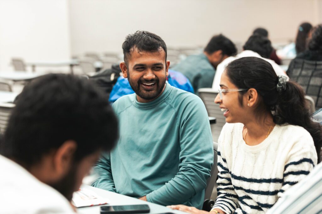 Anderson University international students sitting together talking