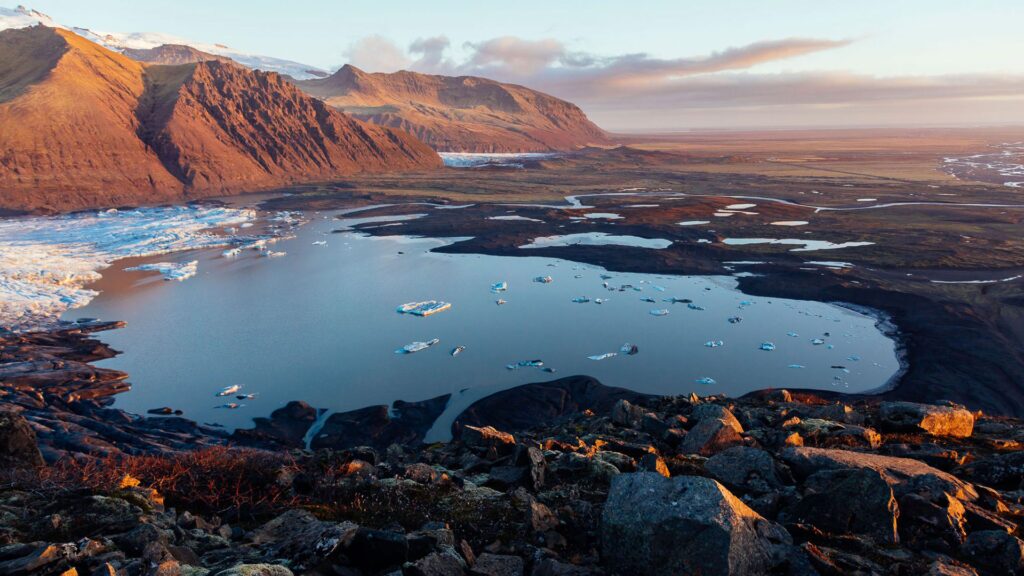 Scenic photograph of mountains by a plateau