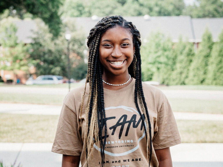 young african american woman in i am mentoring tshirt smiling