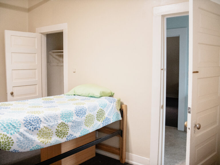 Pratt Denmark Suite Residence Halls bedroom with bed and closet