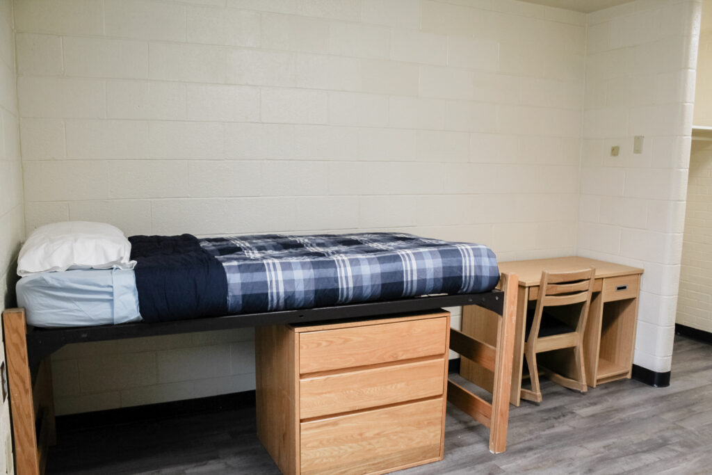 Rouse Suite Residence Halls bedroom with bed and desk