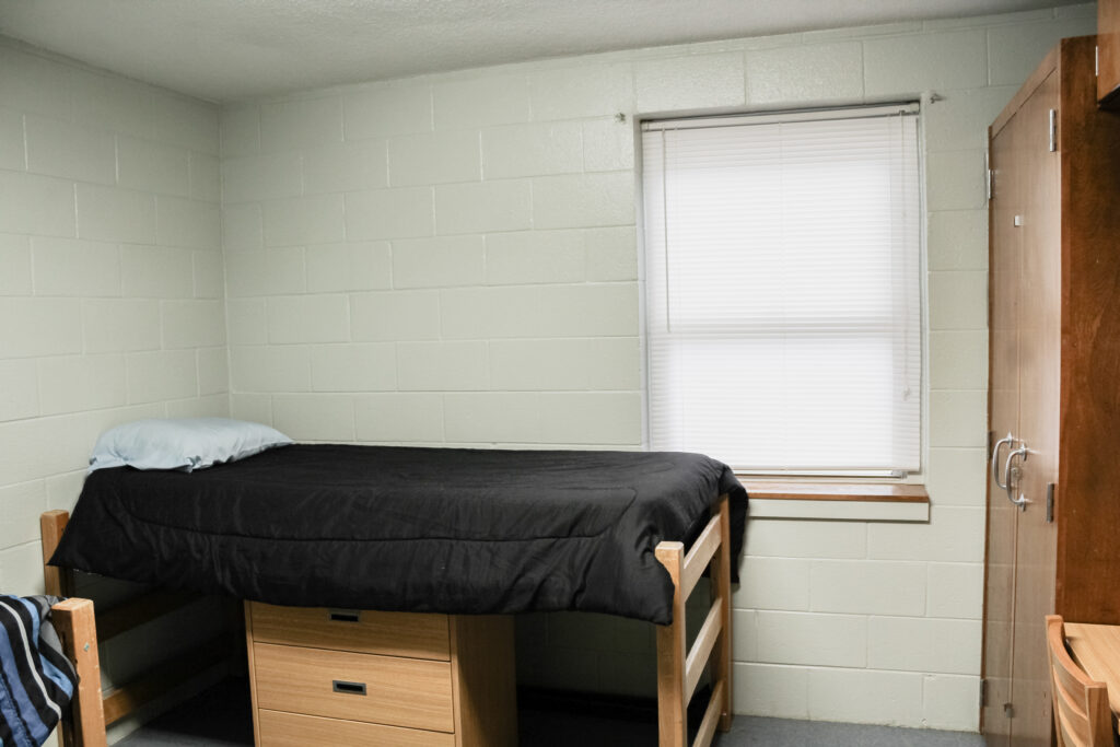 Stringer Apartment Residence Halls bedroom with bed, window, and closet