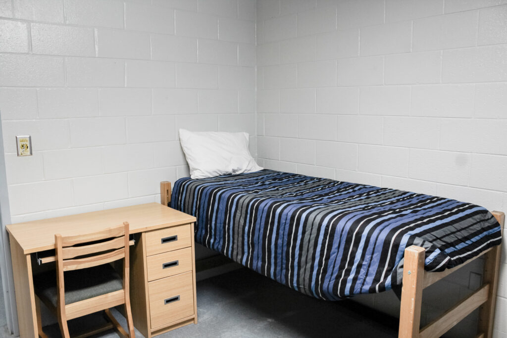 Stringer Apartment Residence Halls bedroom with bed and desk
