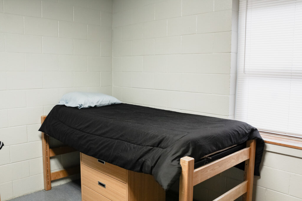 Stringer Apartment Residence Halls bedroom with bed and window