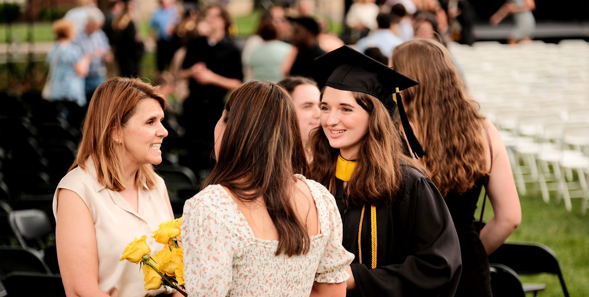 Alumni at Commencement in black and gold regalia