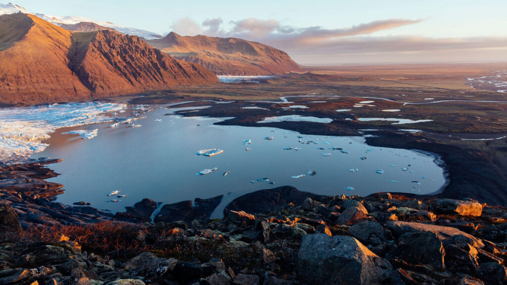 Scenic photograph of mountains by a plateau